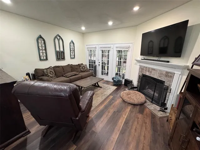 a living room with furniture fireplace and flat screen tv