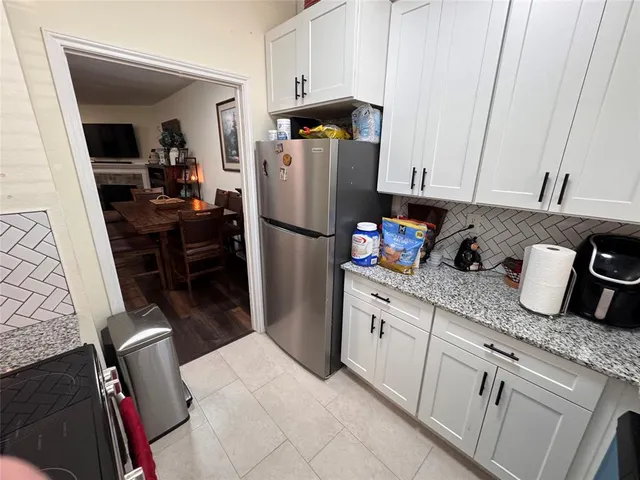 a kitchen with refrigerator and cabinets
