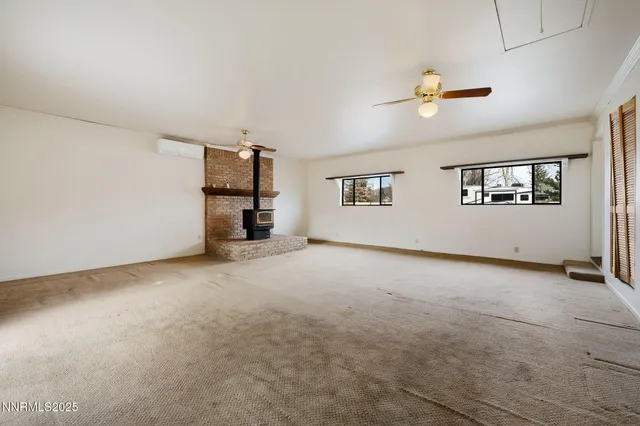 a view of a livingroom with a ceiling fan and window