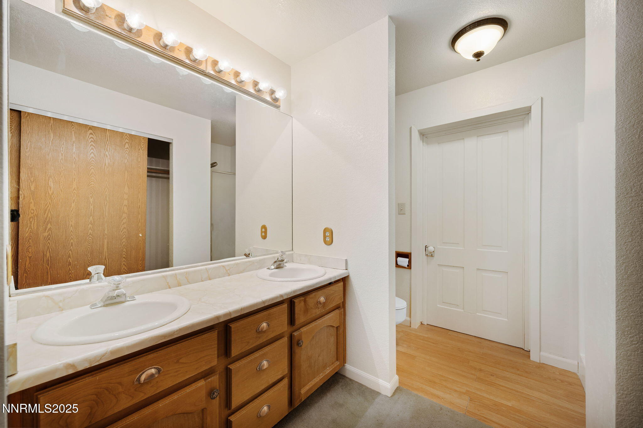 450 Marsh Road Carson City, NV 89701 - Photo 34 of 41 a bathroom with a double vanity sink a large mirror and shower
