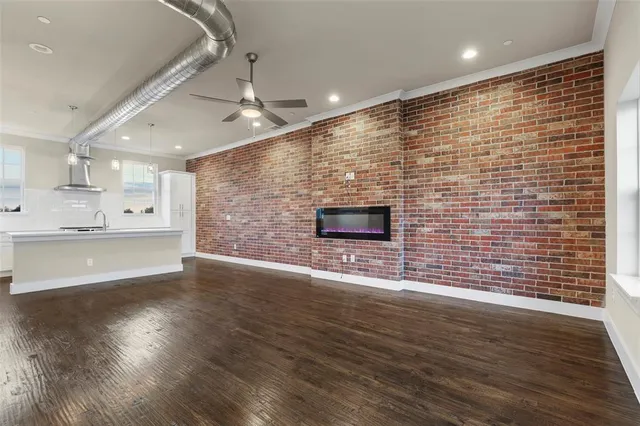 an empty room with wooden floor an empty space and windows