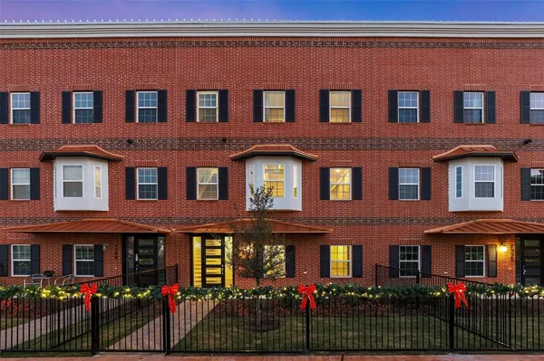a front view of a brick building with many windows