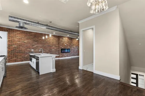 a view of an empty room and wooden floor