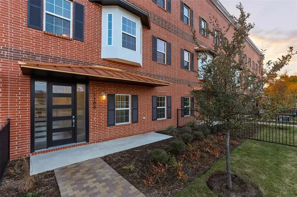 a view of a brick house with many windows