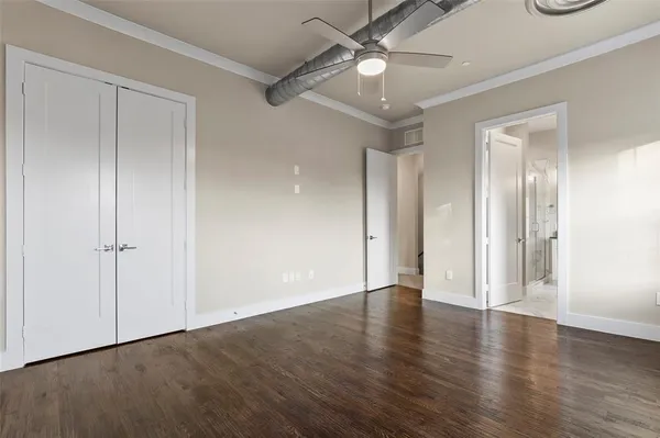 a view of an empty room with wooden floor