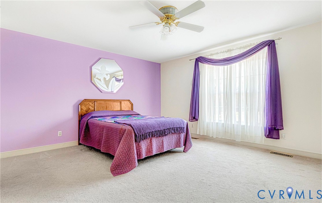 5025 Hurop Road Sandston, VA 23150 - Photo 26 of 57 a bedroom with a bed and a chandelier
