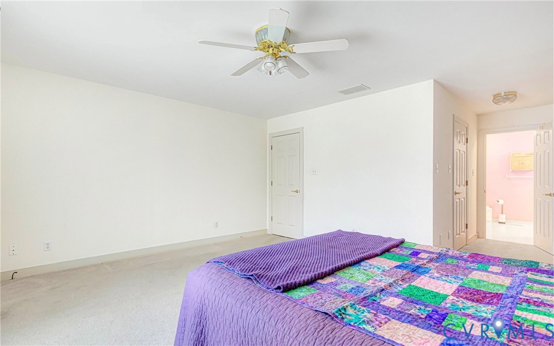 5025 Hurop Road Sandston, VA 23150 - Photo 28 of 57 a bedroom with a bed and a chandelier fan