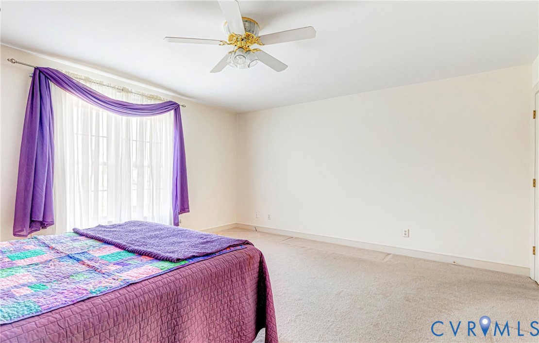 5025 Hurop Road Sandston, VA 23150 - Photo 29 of 57 a bedroom with a bed and a chandelier
