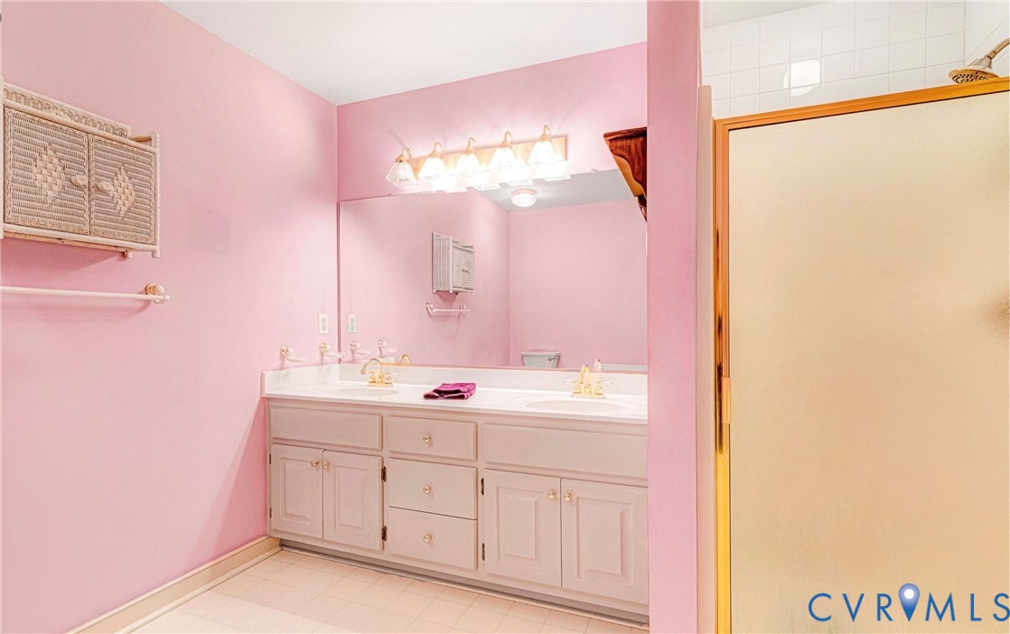 5025 Hurop Road Sandston, VA 23150 - Photo 31 of 57 a bathroom with a double vanity sink and mirror