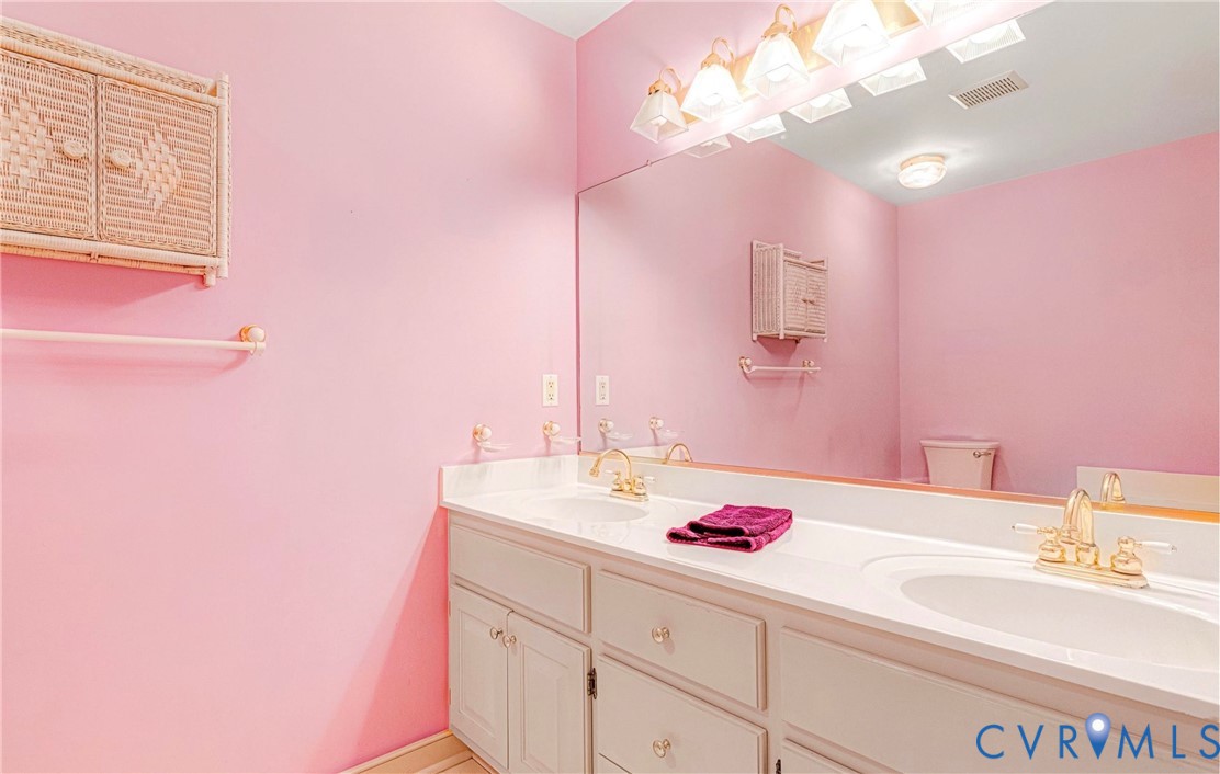 5025 Hurop Road Sandston, VA 23150 - Photo 32 of 57 a bathroom with a sink vanity and a mirror