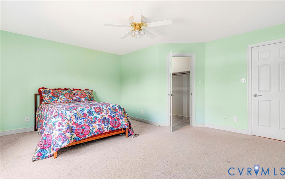 5025 Hurop Road Sandston, VA 23150 - Photo 35 of 57 a bedroom with a bed and a chandelier