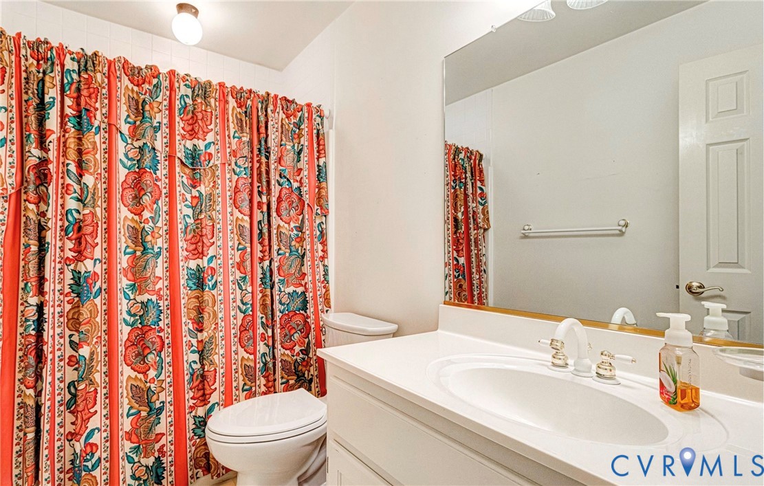 5025 Hurop Road Sandston, VA 23150 - Photo 37 of 57 a bathroom with a sink a toilet and shower curtain