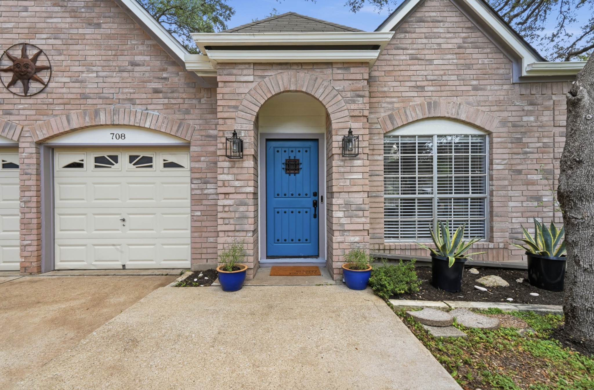 708 Shade Tree Drive Austin, TX 78748 - Photo 9 of 32 Mature landscaping wraps around the home, which offers a spacious front entry area for your seasonal decor.