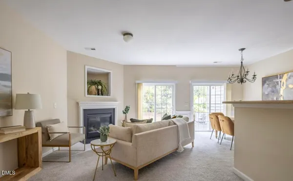 a living room with furniture a chandelier and a fireplace