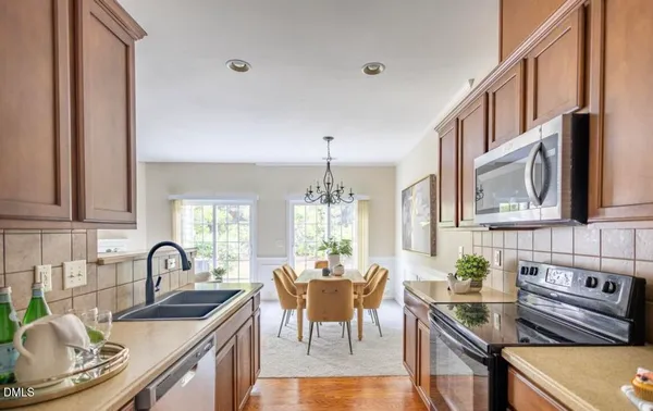 a kitchen with granite countertop a sink stove and cabinets