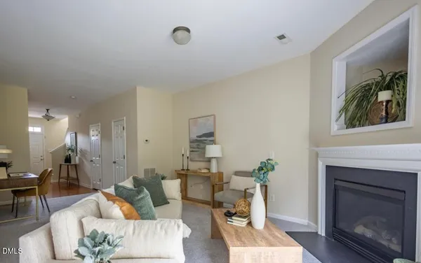 a living room with furniture a fireplace and a flat screen tv