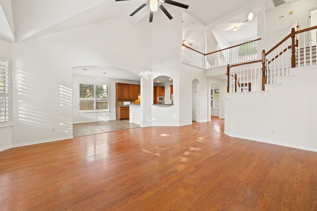 908 Golden Palomino Court Austin, TX 78732 - Photo 12 of 40 a view of a big room with windows and chandelier fan