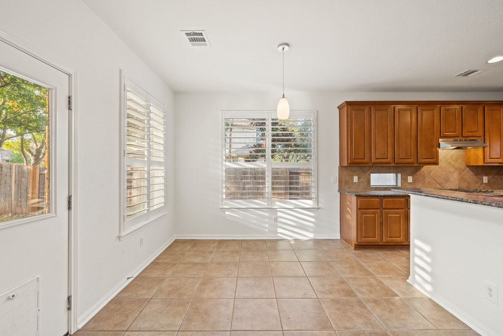 908 Golden Palomino Court Austin, TX 78732 - Photo 13 of 40 a kitchen with a refrigerator oven stove and a sink