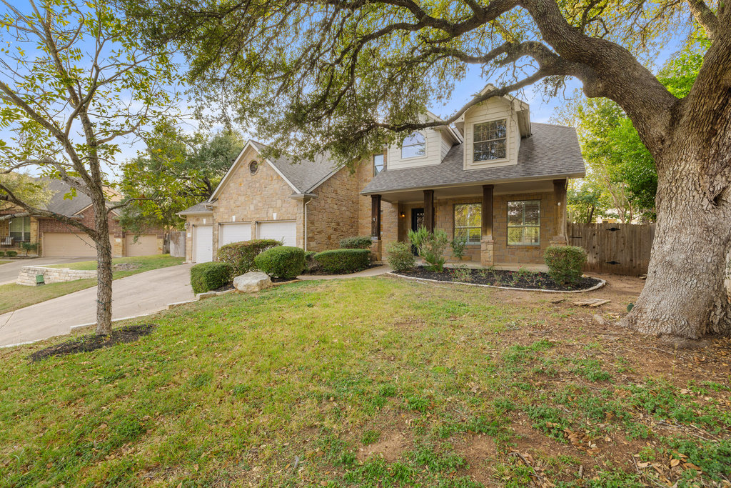 908 Golden Palomino Court Austin, TX 78732 - Photo 2 of 40 a front view of a house with a yard