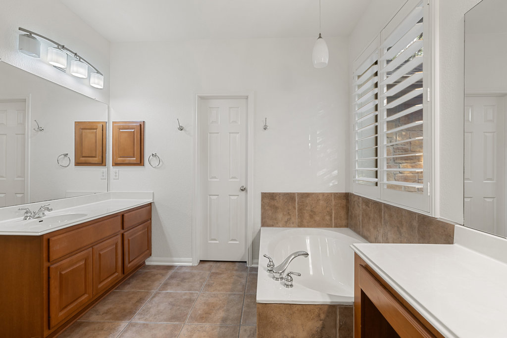 908 Golden Palomino Court Austin, TX 78732 - Photo 21 of 40 a bathroom with a sink and a mirror