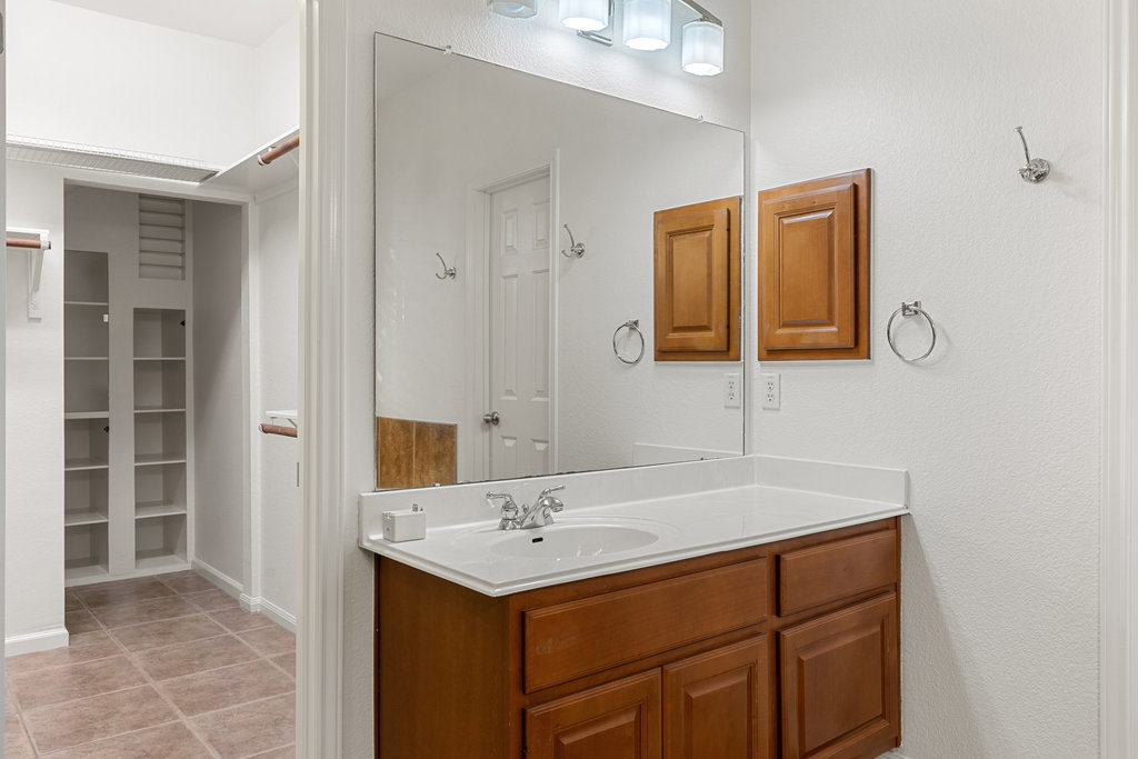 908 Golden Palomino Court Austin, TX 78732 - Photo 22 of 40 a bathroom with a sink and a mirror