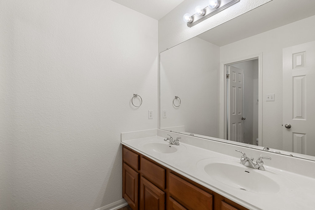908 Golden Palomino Court Austin, TX 78732 - Photo 25 of 40 a bathroom with a sink double vanity and a mirror