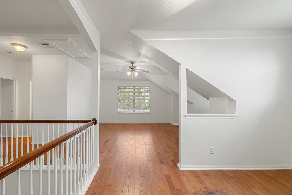 908 Golden Palomino Court Austin, TX 78732 - Photo 28 of 40 a view of an empty room with wooden floor and a window