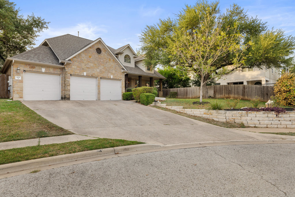 908 Golden Palomino Court Austin, TX 78732 - Photo 3 of 40 a front view of a house with a yard and garage