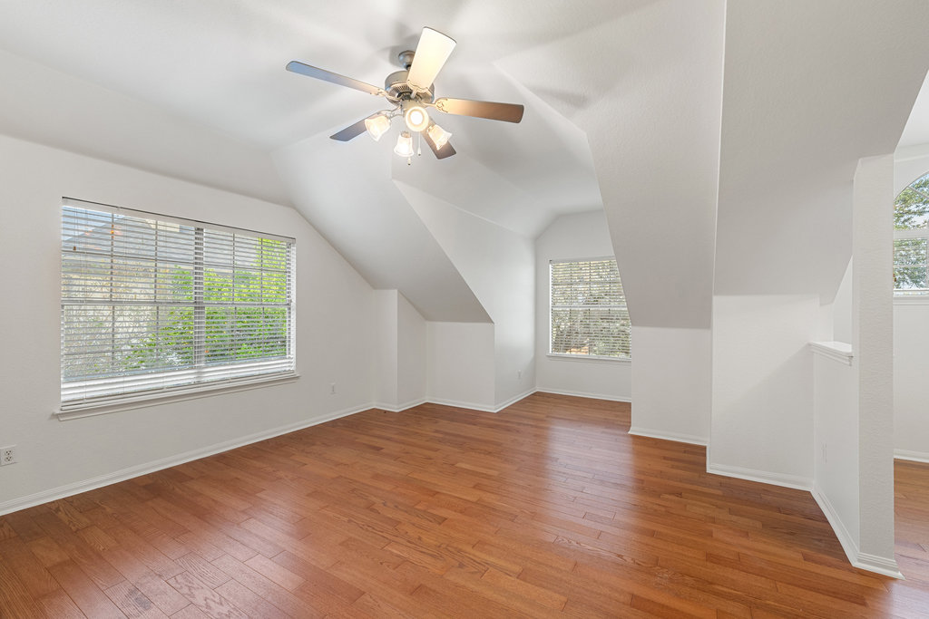 908 Golden Palomino Court Austin, TX 78732 - Photo 31 of 40 a view of an empty room with wooden floor and a window