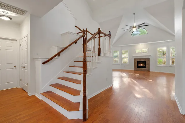 a view of a livingroom with wooden floor and staircase