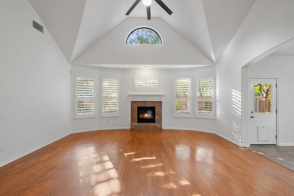 908 Golden Palomino Court Austin, TX 78732 - Photo 10 of 40 a view of an empty room with a window and fireplace