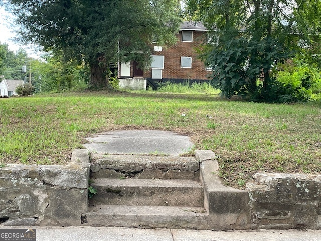 776 Neal Street Northwest Atlanta, GA 30318 - Photo 1 of 1 a front view of a house with a yard and a garage