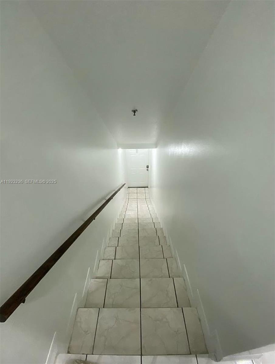 12035 Southwest 14th Street, Unit 103 Miami, FL 33184 - Photo 13 of 17 a view of an empty room and window