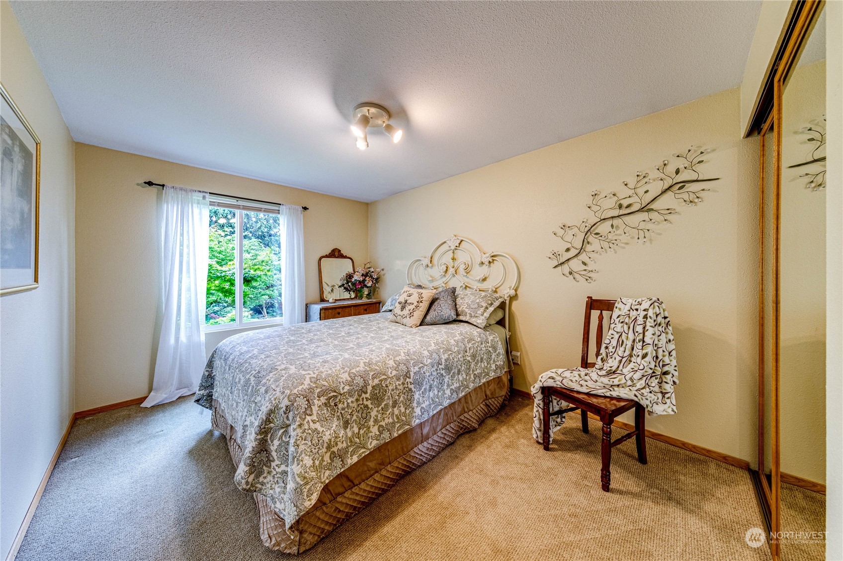 17129 North Road Bothell, WA 98012 - Photo 12 of 40 a bedroom with a bed and a chair