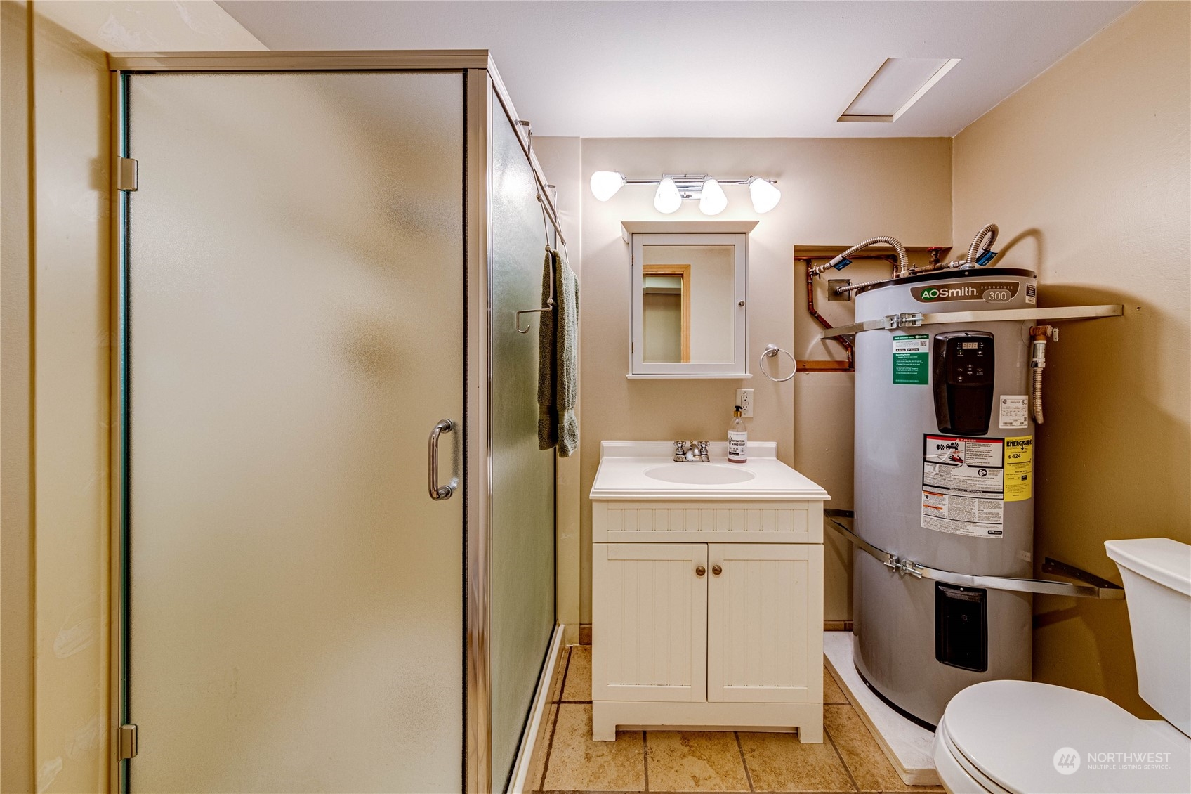 17129 North Road Bothell, WA 98012 - Photo 20 of 40 a bathroom with a granite countertop sink toilet and shower