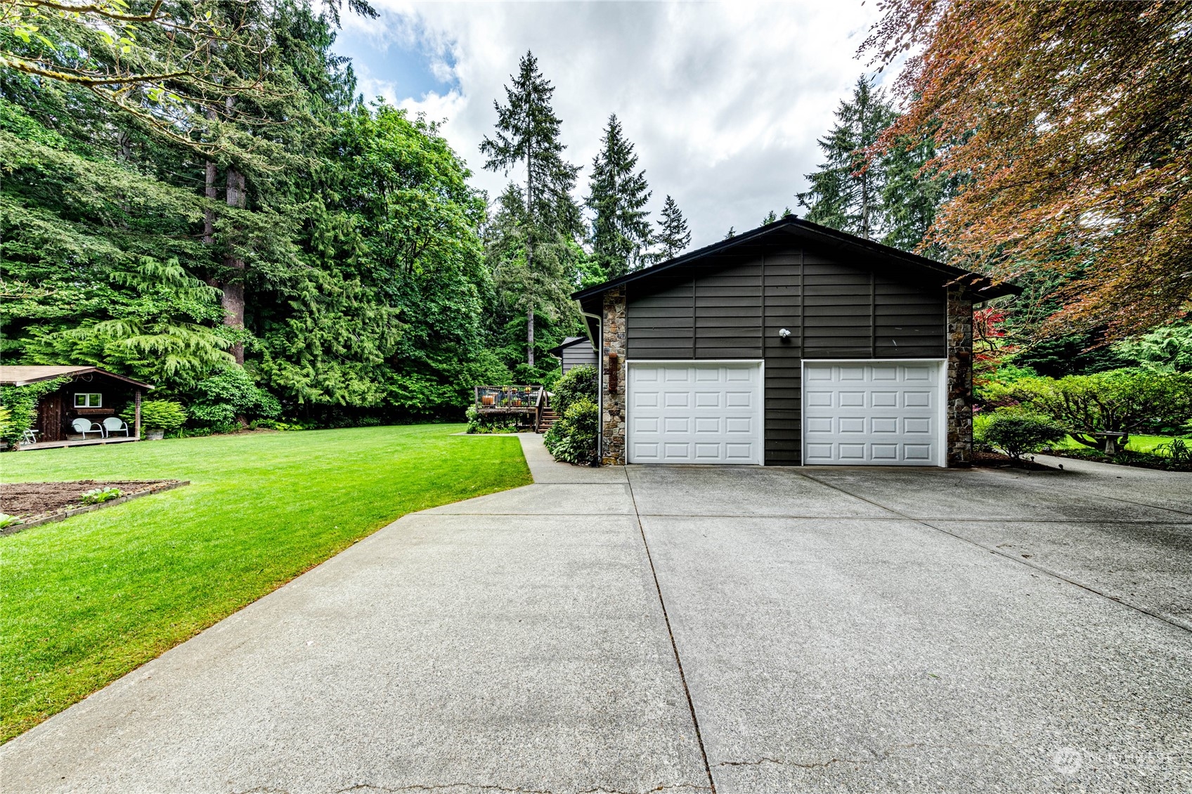 17129 North Road Bothell, WA 98012 - Photo 27 of 40 a front view of house with yard and trees