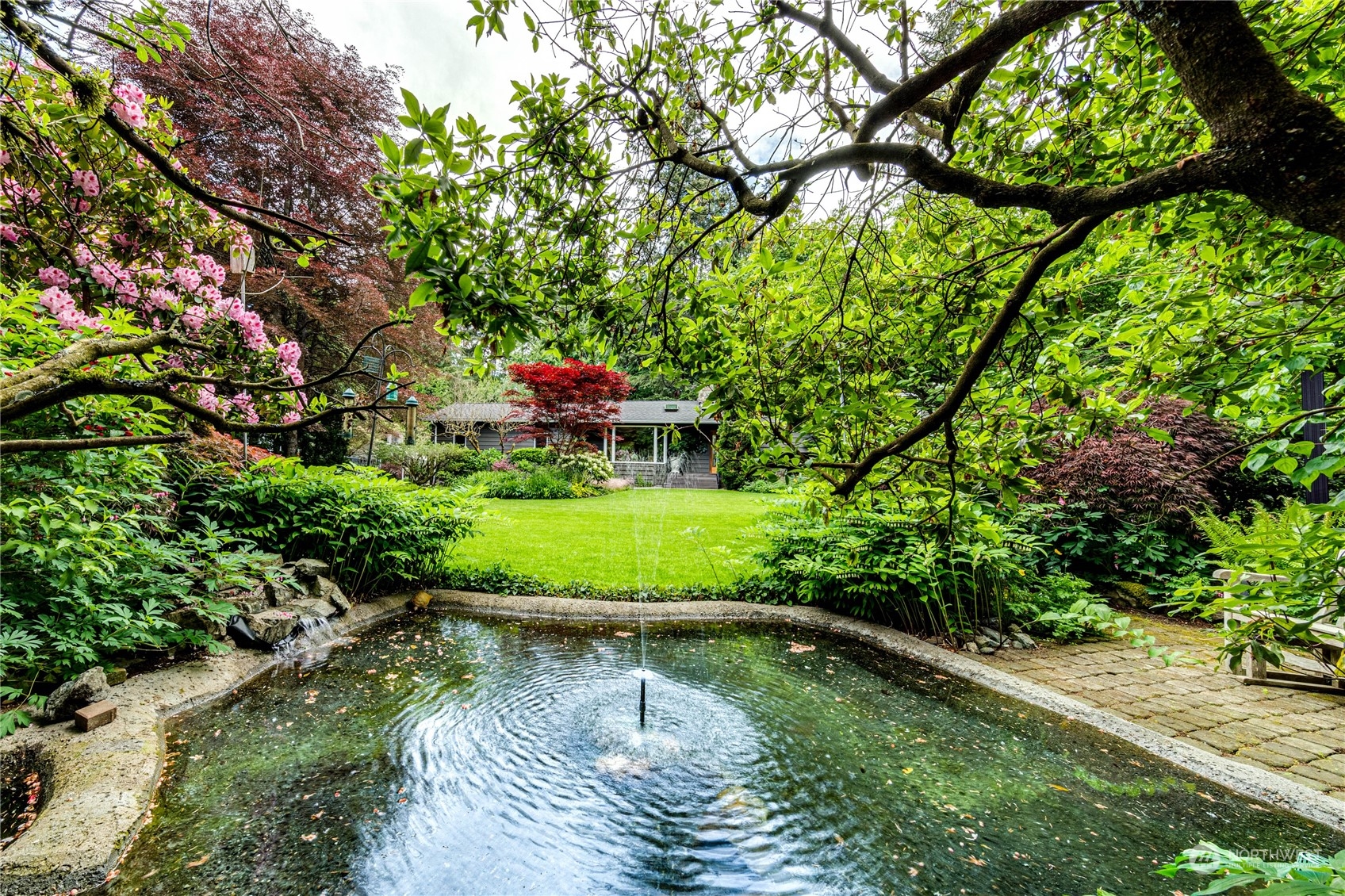 17129 North Road Bothell, WA 98012 - Photo 33 of 40 a view of a lake with a yard and large trees
