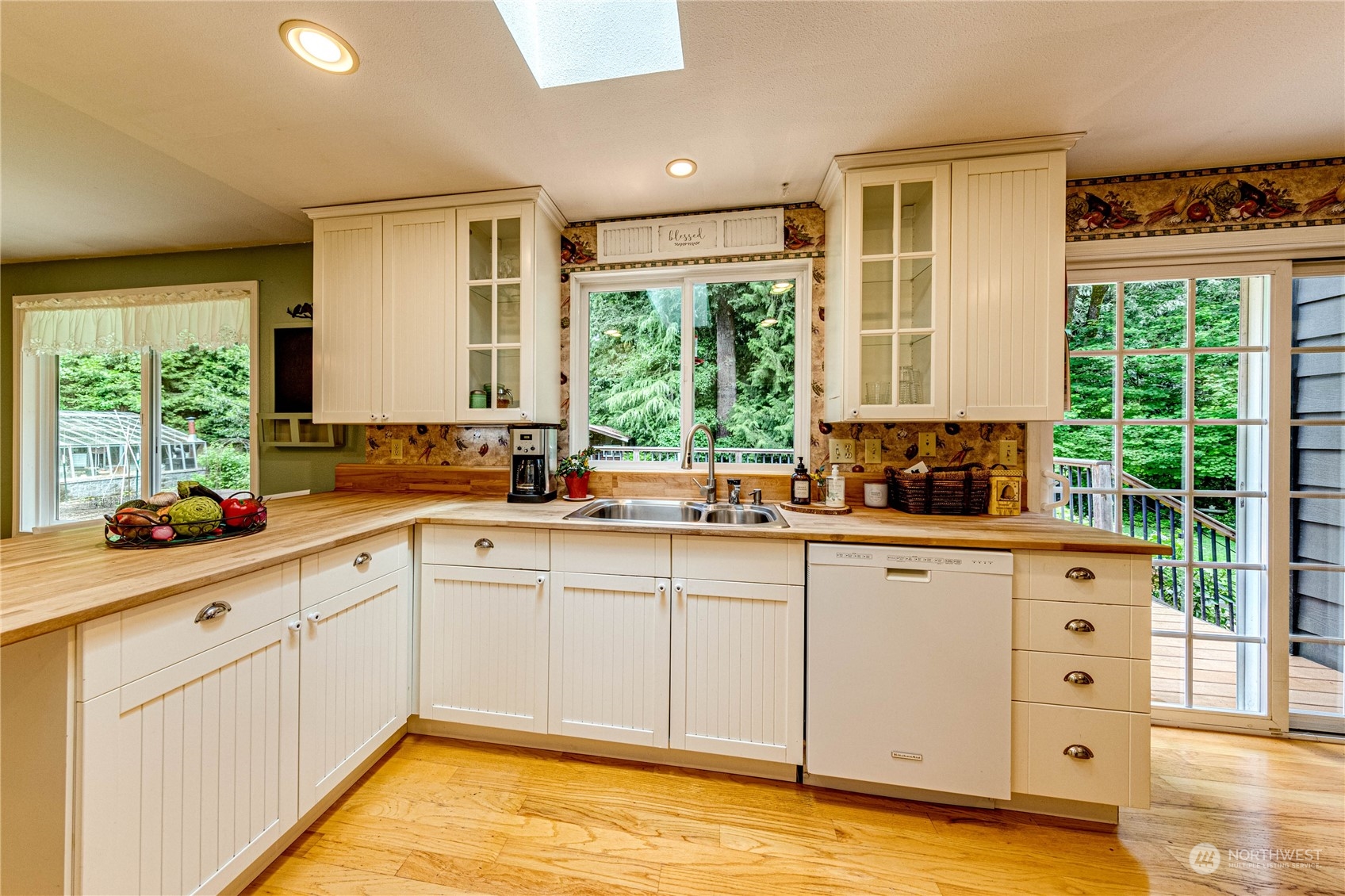 17129 North Road Bothell, WA 98012 - Photo 7 of 40 a kitchen with a window a sink and a cabinets