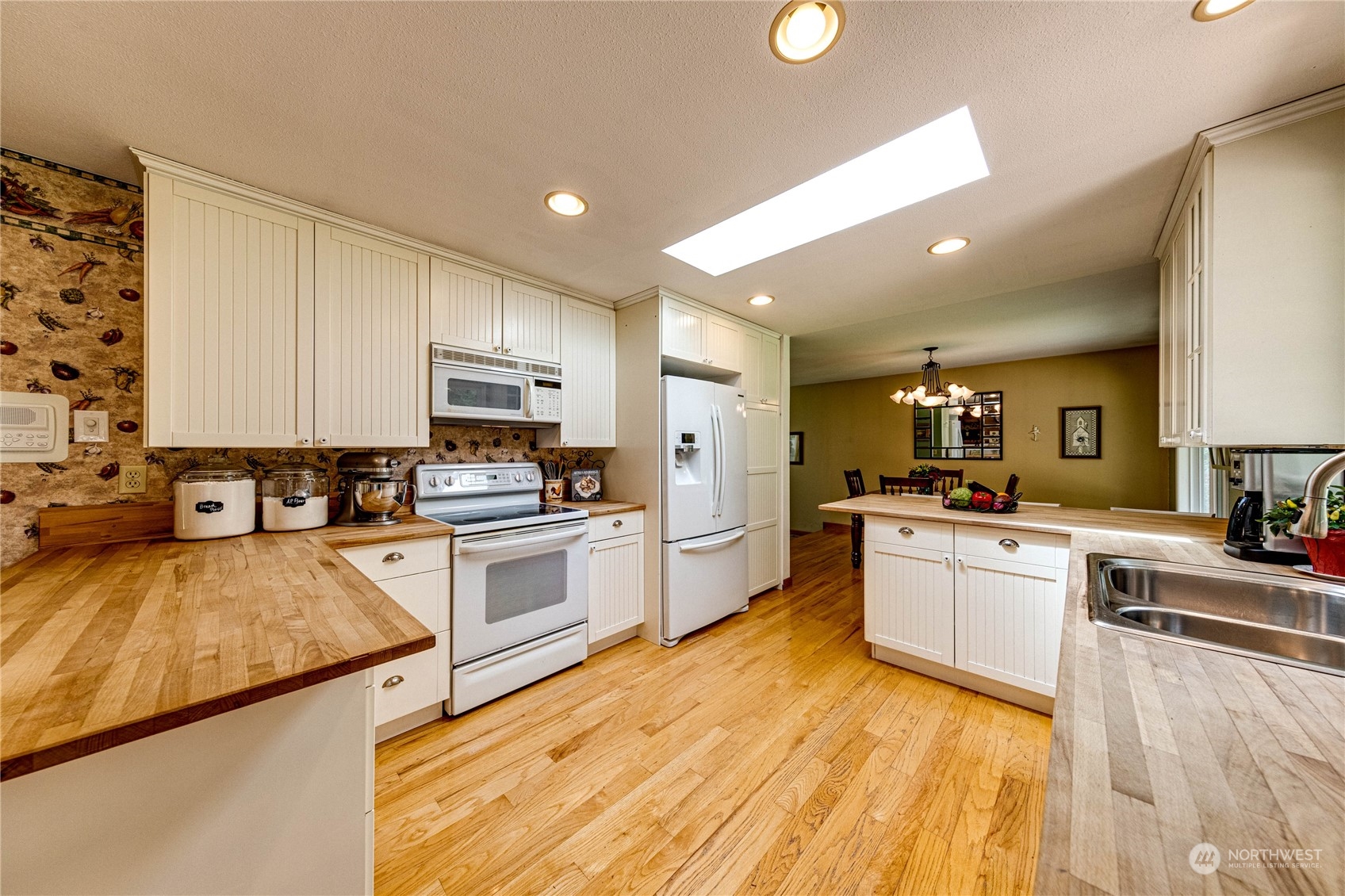 17129 North Road Bothell, WA 98012 - Photo 8 of 40 a large kitchen with granite countertop a large counter top stainless steel appliances and cabinets
