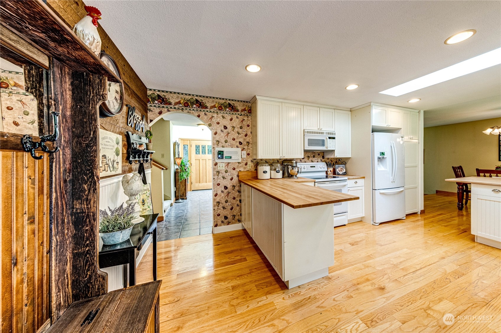 17129 North Road Bothell, WA 98012 - Photo 9 of 40 a kitchen with stainless steel appliances kitchen island granite countertop a stove refrigerator and a sink