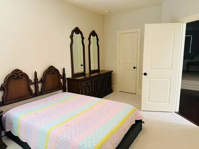a bed room with two bed and a large mirror