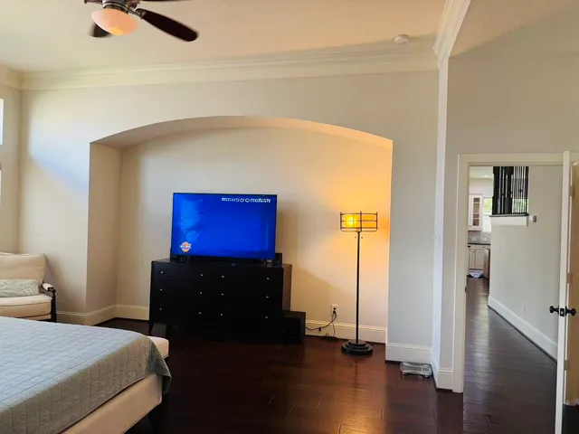 a bedroom with a bed and wooden floor