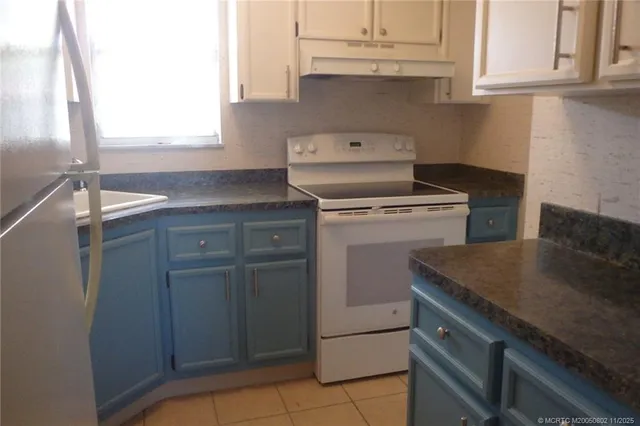 a kitchen with cabinets appliances and a sink