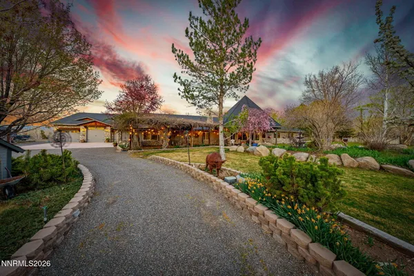 a view of a house with backyard and sitting area