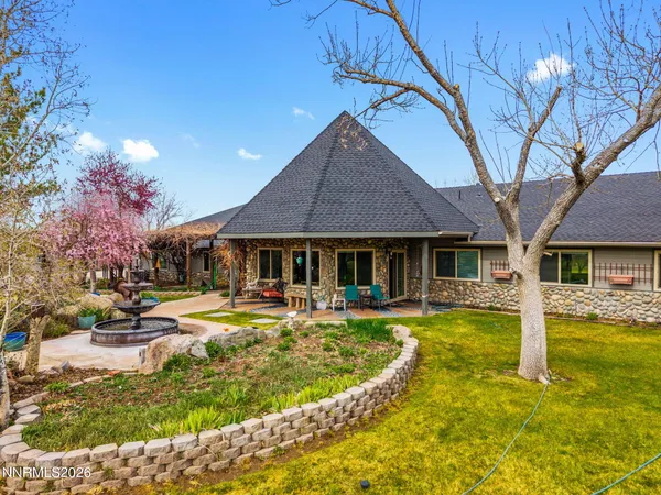 a outdoor space with lots of furniture and lots of potted plants