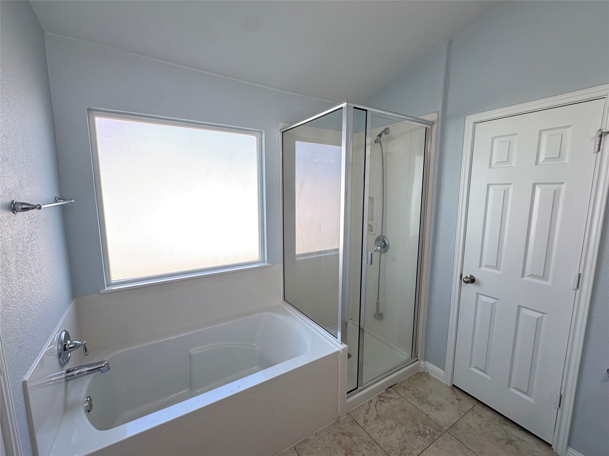 1520 Portchester Castle Path Pflugerville, TX 78660 - Photo 13 of 26 A well-appointed bathroom offers both a spacious soaking tub and a sleek, modern walk-in shower.