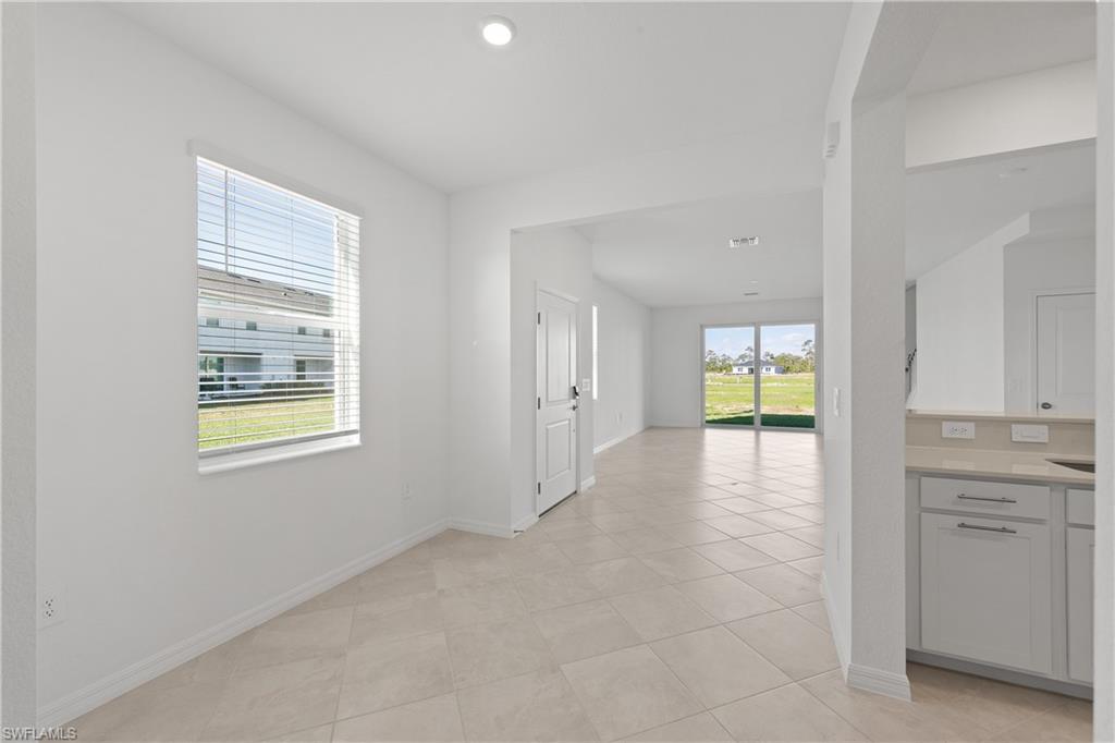 15035 White Pearl Road Babcock Ranch, FL 33982 - Photo 15 of 43 a view of an empty room with a window and a kitchen