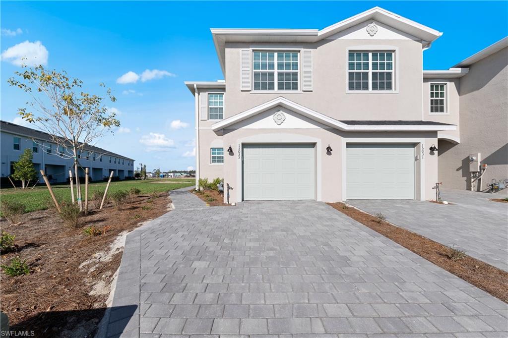 15035 White Pearl Road Babcock Ranch, FL 33982 - Photo 2 of 43 a front view of a house with a yard and garage