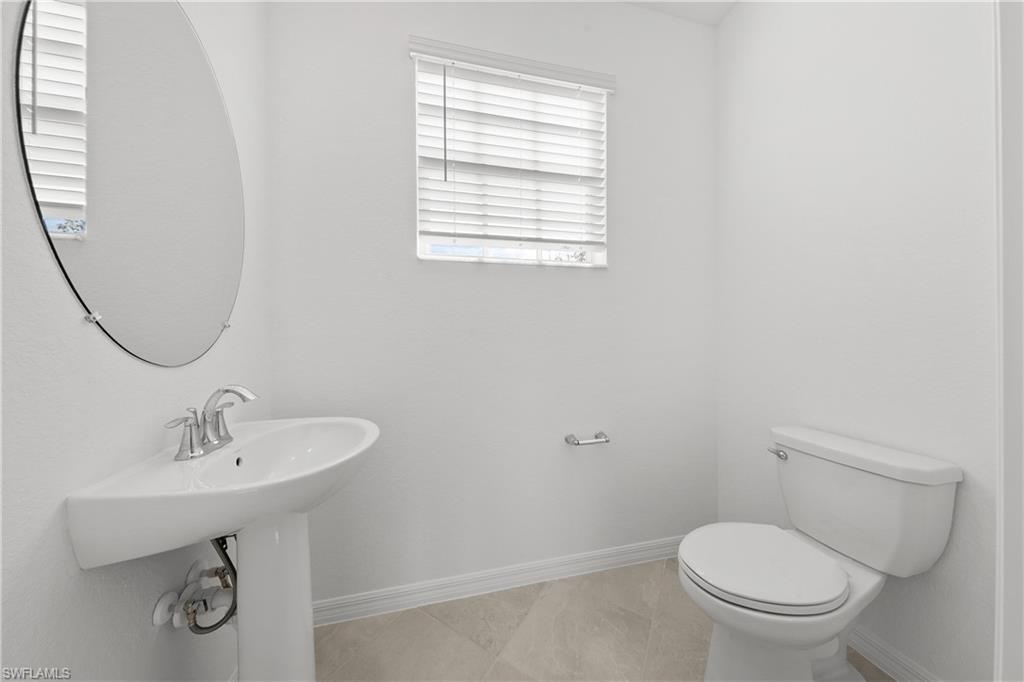 15035 White Pearl Road Babcock Ranch, FL 33982 - Photo 29 of 43 a bathroom with a sink a toilet and a mirror