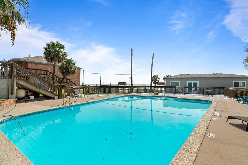 919 North Fulton Beach Road, Unit 324 Fulton, TX 78382 - Photo 15 of 21 a view of a swimming pool with a chair and tables